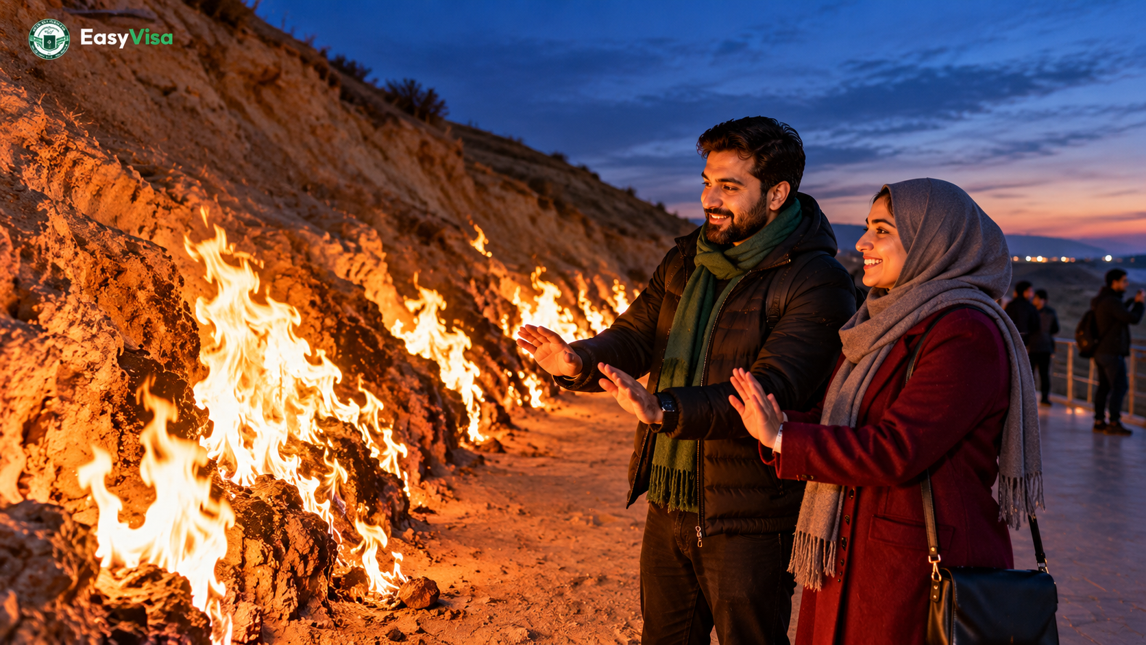 Pakistani couple warming their hands near the natural gas flames of Yanardag on the Absheron Peninsula at dusk