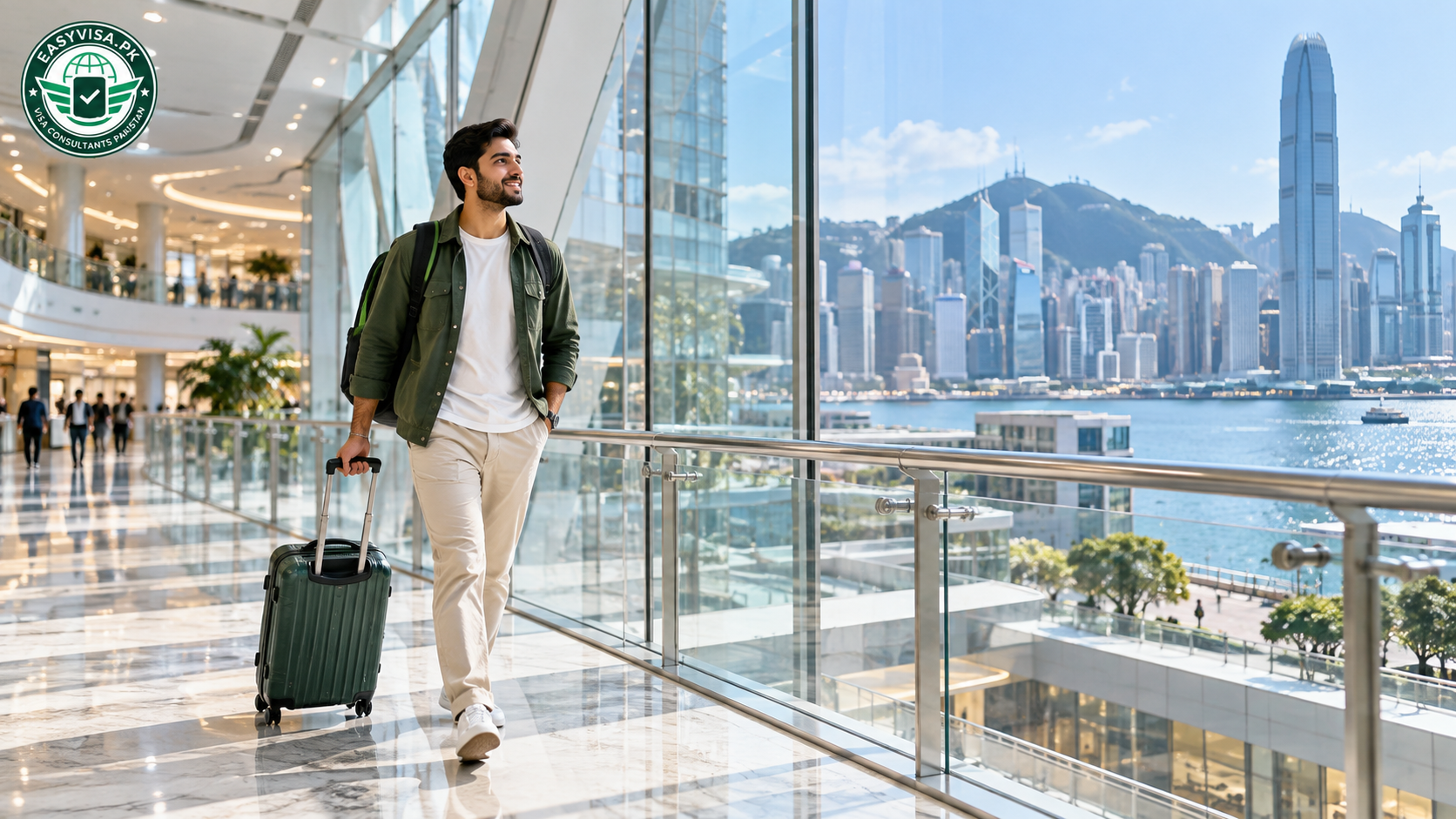 Traveller walking a glass skybridge in a modern Hong Kong mall with harbour view