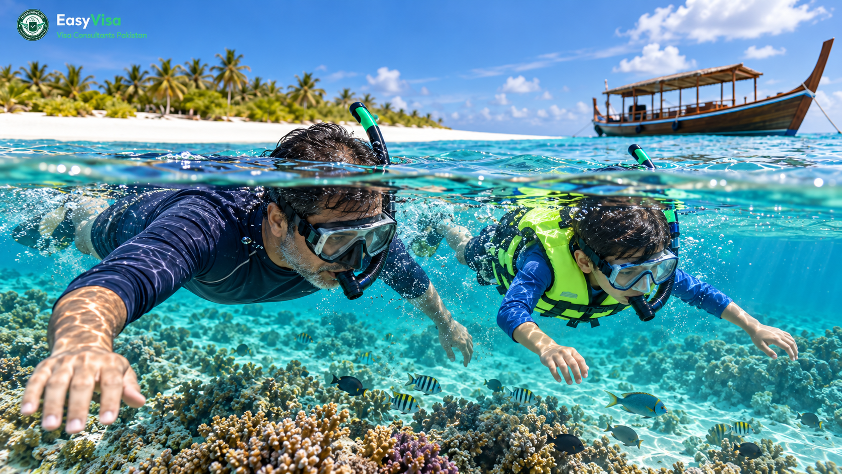 Pakistani father and son snorkelling together in a clear turquoise lagoon beside a sandbank in the Maldives