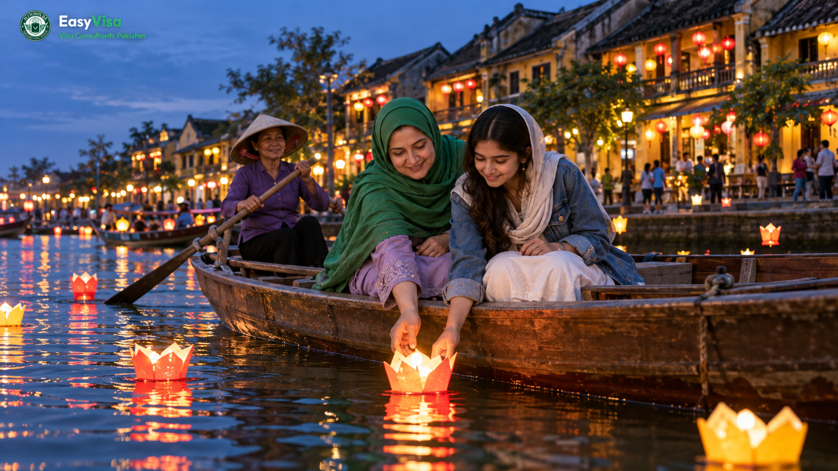 Pakistani mother and teenage daughter releasing a paper lantern from a small boat on the Thu Bon river in Hoi An Ancient Town at dusk