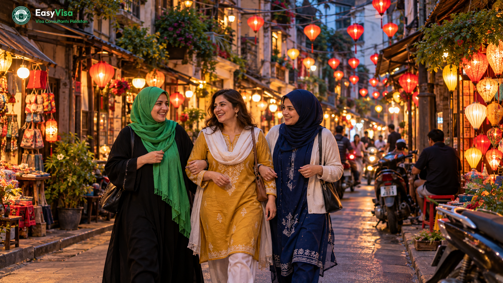 Three Pakistani women friends in their thirties walking through Hanoi's Old Quarter under strings of red lanterns in the evening