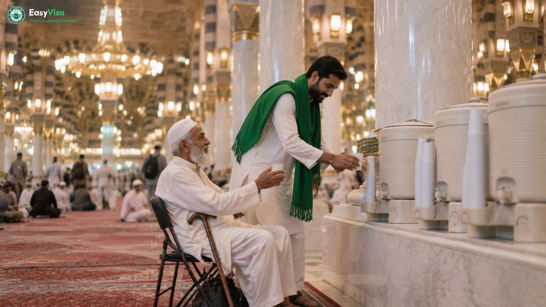 Pakistani son pouring Zamzam water for his elderly father from a Zamzam cooler inside the carpeted prayer hall of Masjid an-Nabawi in Ramadan