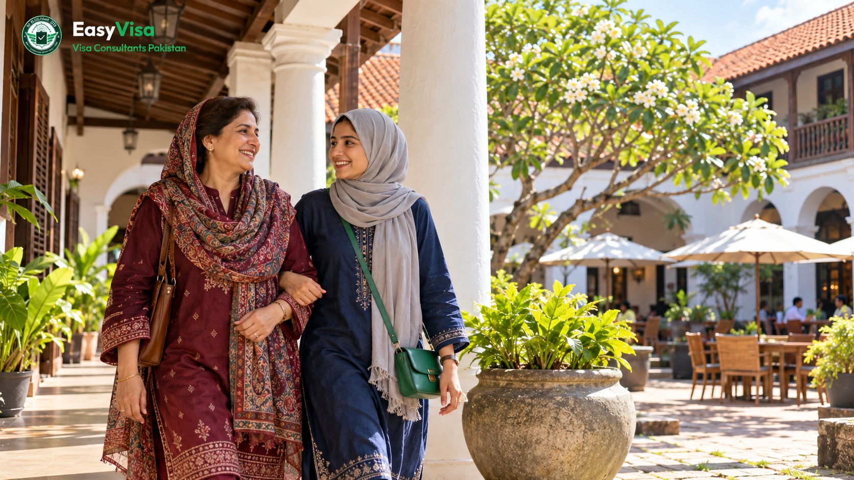 Pakistani mother and adult daughter smiling in the whitewashed colonial courtyard of the Old Dutch Hospital in Colombo Fort