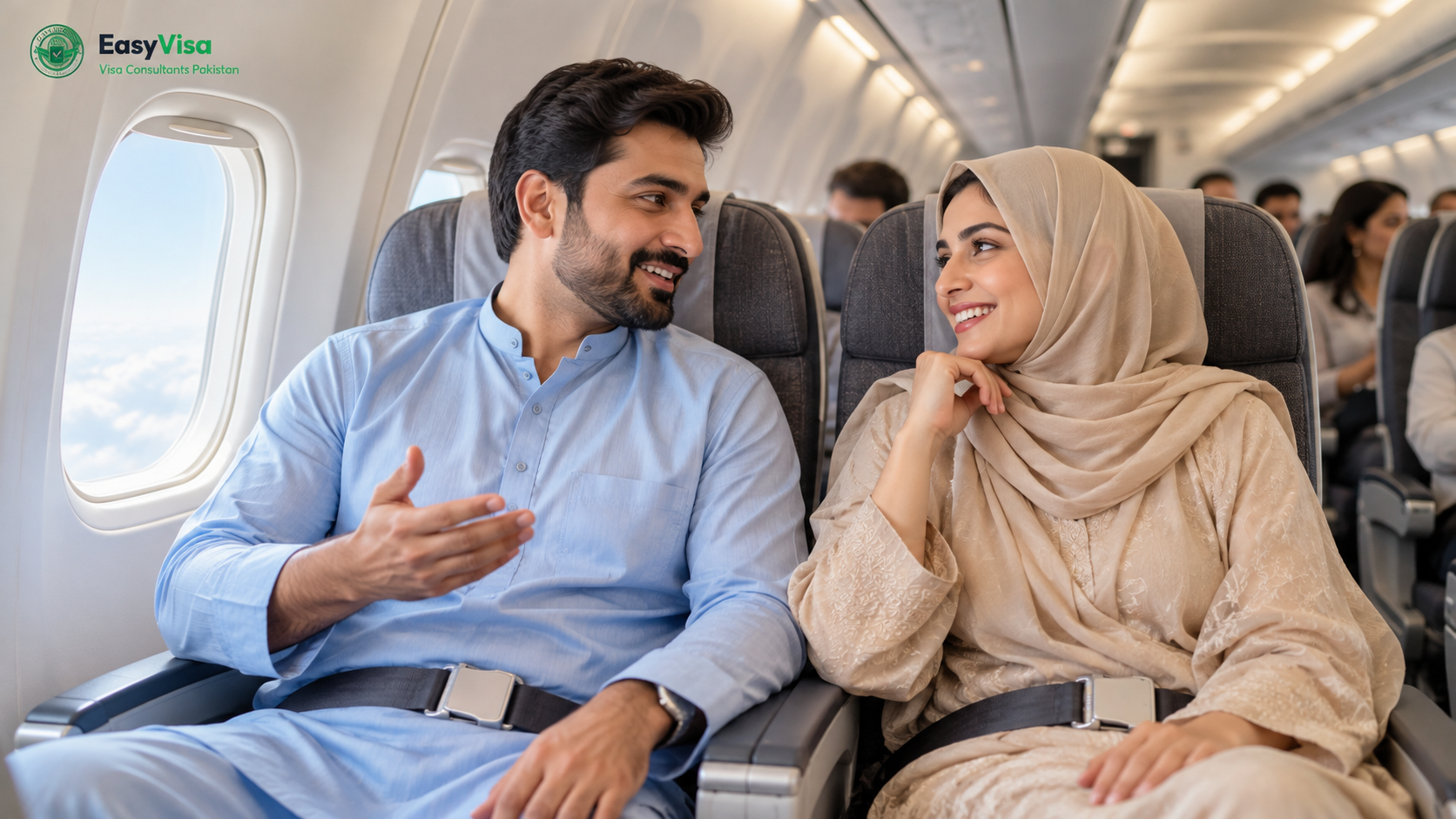 Pakistani couple seated in a generic aircraft cabin looking toward the aisle, no airline livery